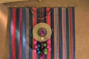 a straw hat and some beads on a curtain at Casita La Brea in San Pedro de Atacama