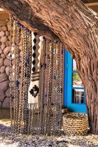 a bunch of necklaces hanging from a tree branch at Casita La Brea in San Pedro de Atacama