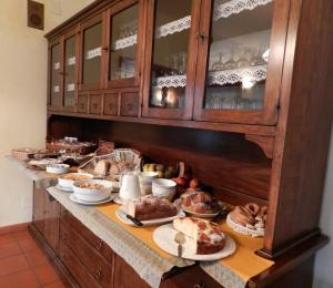 a buffet with many different types of food on a counter at Hotel Panoramique in Aosta