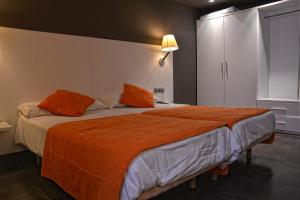 a hotel room with a bed and two lamps at Hotel Can Batiste in Sant Carles de la Ràpita