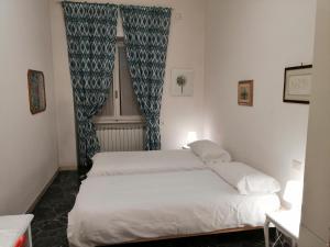 a bedroom with two beds and a window at Pier Capponi Apartament in Florence