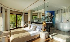 a bedroom with a bed and a bath tub and a sink at Marti Hemithea Hotel in Orhaniye +56 photos