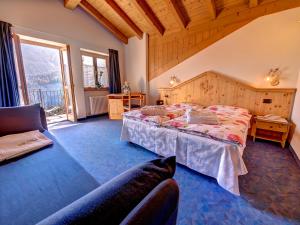 a bedroom with a large bed and a large window at Hotel Negritella in Folgarida +33 photos