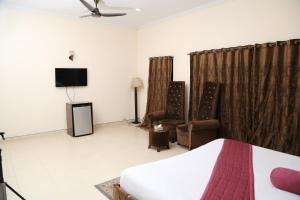 a hotel room with a bed and a tv at Westin Suites in Lahore +34 photos
