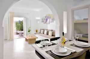 a living room with a table and a couch at AC Village Christoulis in Mýkonos City