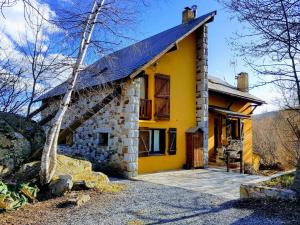 a yellow brick house with a gambrel roof at EL Balcó de Dorres in Dorres