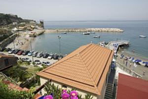 a view of a beach with a red roof at Hotel Baia Di Puolo in Massa Lubrense