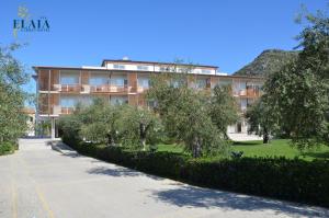 a large building with trees in front of it at Elaia Garden Hotel in Sperlonga