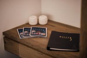a table with a book and two magazines on it at Apartments Master 5 in Herceg-Novi
