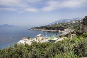 a small island in the middle of a body of water at Hotel Baia Di Puolo in Massa Lubrense