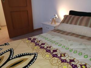 a bedroom with a bed with a blanket on it at Casa L'abbraccio in Livorno