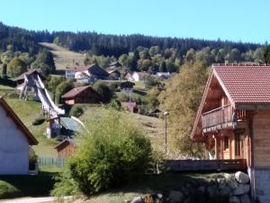a small village in the mountains with a playground at Gîte 60M2 in Xonrupt-Longemer