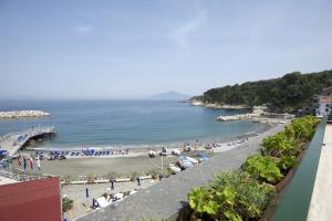 a view of a beach with people on the sand at Hotel Baia Di Puolo in Massa Lubrense