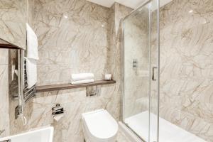 a bathroom with a toilet and a shower at Terlon Apartments in Liverpool +57 photos