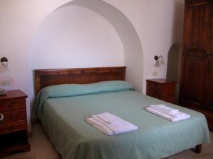 a bedroom with a bed with two towels on it at Masseria Casamassima agriturismo in Ostuni