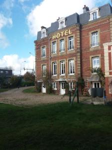 a large red brick hotel with a sign on it at Hotel du chateau blanc in Saint-Aubin-lès-Elbeuf
