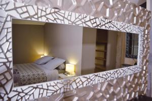 A bed or beds in a room at Les Terrasses de Castelnau