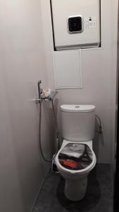 a small bathroom with a toilet with a shower at 12 Pargi in Narva-Jõesuu