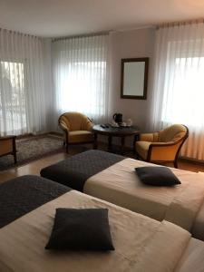um quarto de hotel com duas camas e uma mesa em Monte Christo em Miastko