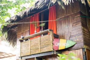 a wooden house with a surfboard in front of a window at The Humpback Turtle in El Valle