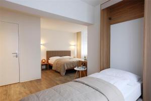 Postel nebo postele na pokoji v ubytování Hotel Work Life Residence am Bahnhof
