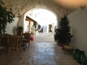 an archway in a building with a table and chairs at Masseria Casamassima agriturismo in Ostuni