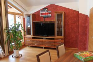 a living room with a large entertainment center with a television at Haus Bergheim in Unken