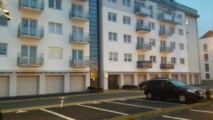 a car parked in a parking lot in front of a building at PANORAMA KOSZALIN in Koszalin