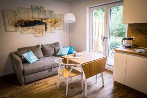 a living room with a table and a couch at WeststrandPur in Norderney