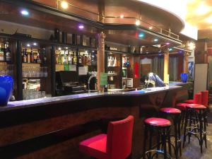 a bar with red stools in a restaurant at Motel Sofia in Sežana