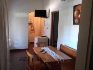 une pièce avec une table, des chaises et une télévision dans l'établissement Hosteria y Cabañas Los Mimbres, à San Esteban