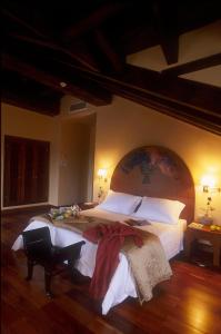 a hotel room with a bed and a dresser at Hotel El Rancho in Torrecaballeros