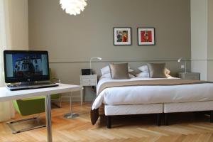 - une chambre avec un lit et un bureau avec un ordinateur portable dans l'établissement Villa Élyane, à Colmar