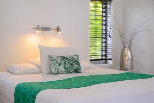 מיטה או מיטות בחדר ב-Makayla Palms