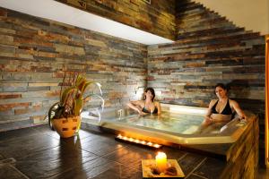 two women sitting in a hot tub in a room at Hotel Life in Rimini