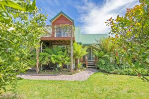 a house with a red roof and some trees at Aloft Boutique Accommodation in Strahan