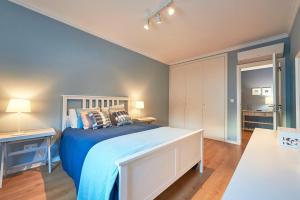 a bedroom with a bed with a blue bedspread at Solar do Monte in Estoril
