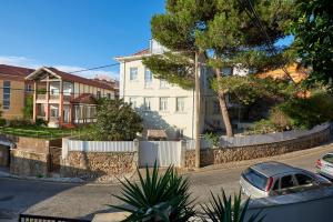 a car parked in front of a house with a fence at Solar do Monte in Estoril