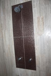 a shower with a glass door on a wooden floor at Casa Wilo in Cancún