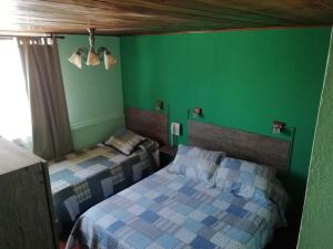 Postel nebo postele na pokoji v ubytování Hostal Dinamarca