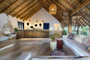 
a living room filled with furniture and a large window at Punta Rucia Lodge in Punta Rucia
