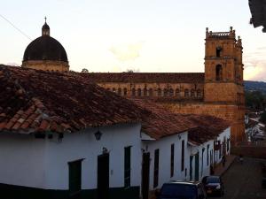 a large building with a clock tower in a city at Casa Doña Rosaura Barichara ALQUILER Entero in Barichara