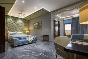 a bedroom with a king sized bed and a desk at O:LV Fifty Five Hotel - Adults Only in San Juan +41 photos