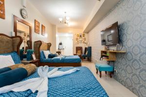 a hotel room with two beds and a tv at Home Of Soleil in Tagaytay
