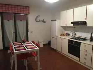 a small kitchen with a table and a stove at Boccaccio Apartment in Sesto Fiorentino