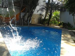 a swimming pool with a water fountain at Pousada Arte Colonial - Casarão Histórico do Séc XVIII - Lancha Própria in Paraty