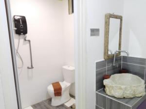 a bathroom with a toilet and a sink at The Serai Cottage Boutique Hotel in Kuala Berang +33 photos