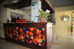a store with a colorful glass display in a room at Pandu Lakeside Hotel Parapat in Parapat