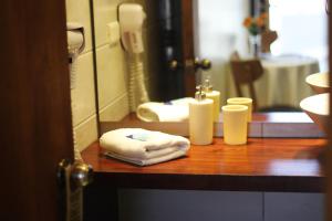 a bathroom with a counter with towels and a mirror at Hotel D&V Concepción in Concepción +9 photos