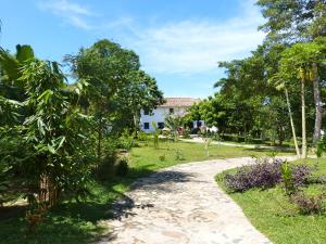 a path through a garden with a house in the background at Tropical Dream Villa in Unawatuna